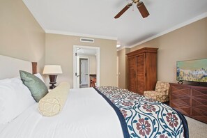 A hotel room with a bed, a television, a wardrobe, and a ceiling fan. - Honua Kai | Ocean View 4 BR, Sleeps 14 | Car Incl. w/ 6+ Nights | HKK ML-1305 by KBM (Lahaina)