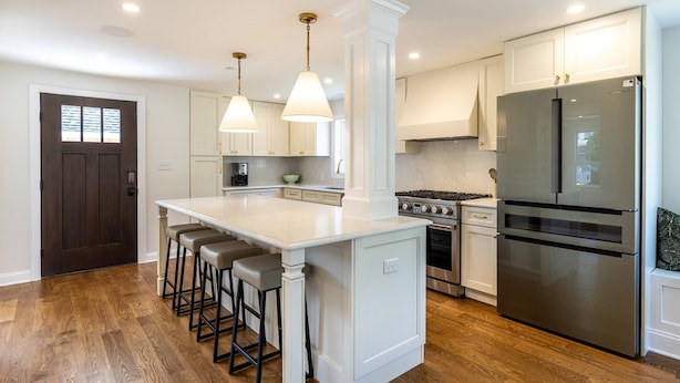 A modern kitchen with a central island, stainless steel appliances, and pendant lighting. - Walk Everywhere From Eastport Cape Cod with Gourmet Kitchen (Annapolis)