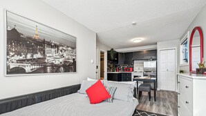 Une chambre d’hôtel moderne dotée d’un grand lit, d’un coin repas et d’une cuisine.