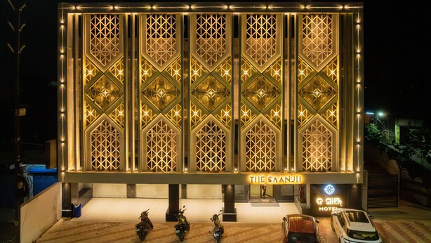 A hotel with a geometric facade and illuminated signage. - The Saanjh Hotel (Angul)