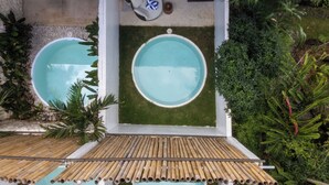 A rooftop pool area with three circular pools, a bamboo pergola, and surrounding greenery. - Solis Loft Villa by Betterplace (Canggu)