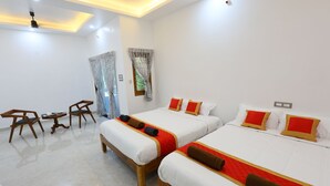 A hotel room with two beds, a small table, chairs, and a ceiling fan. - Star Eden Residency (Chinna Veerampattinam)