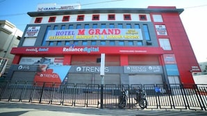 A hotel with signage for "Hotel M Grand" and "Trends" on the facade. - Hotel M Grand (Hyderabad)