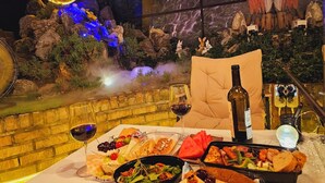 A dining table with a variety of food, wine, and a bottle of wine. - Polo Hotel (Incheon)