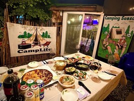 A dining table with various dishes, drinks, and a banner reading "CampLife".
