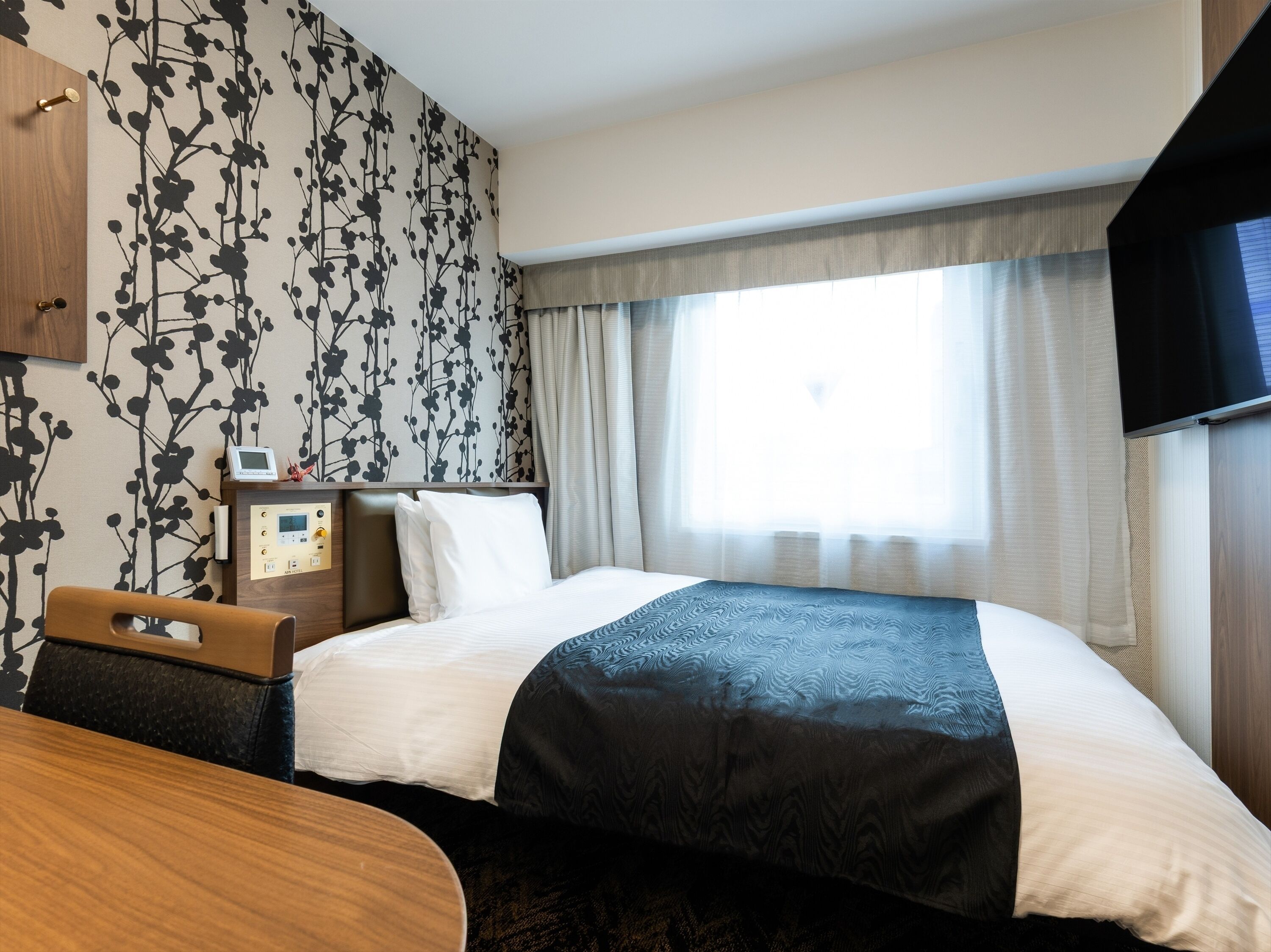 Cubrecamas, escritorio y espacio para trabajar con laptop 