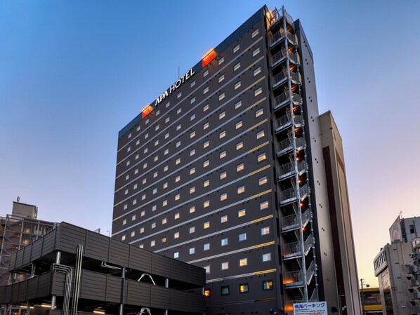 A high-rise building with a sign reading "APA HOTEL" at the top. - APA Hotel Morioka Ekimae (Morioka)