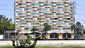A multi-story hotel with a modern facade, featuring a patterned window design and signage for 'The PUB LYC'. - The Publyc Hotel (Bangkok)