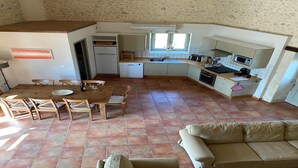 A compact kitchen with a dining area, a built-in oven, and a microwave. - Charming Home in Dordogne near Vineyards (Chalais)