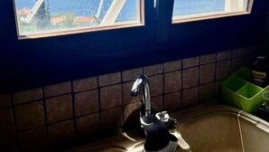 A kitchen with a window overlooking a body of water and mountains. - Sea view villa apartment Monastiraki Nafpaktos (Monastiraki)