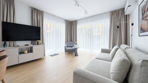 Apartment (A30) | Living area | 30-inch flat-screen TV with satellite channels