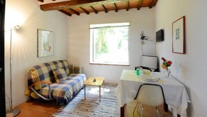 A cozy room with a sofa, a small table, and a window providing natural light. - Awesome home in Montechiari with WiFi (Montechiari)
