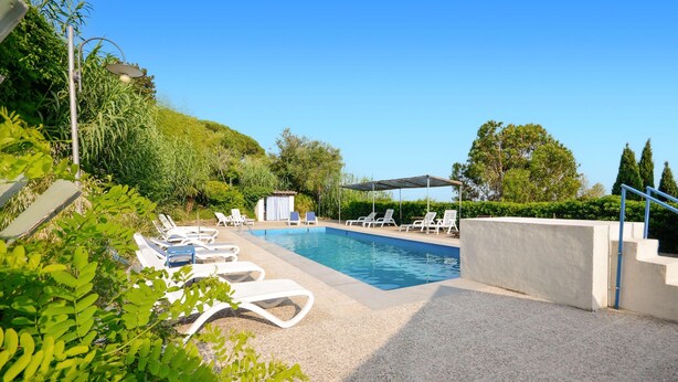 A pool area with lounge chairs, a covered seating area, and a view of the surrounding greenery. - Awesome home in Montechiari with WiFi (Montechiari)