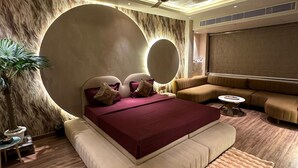 A modern bedroom with a large bed, a ceiling fan, and a large mirror. - Dream Desire (New Delhi)