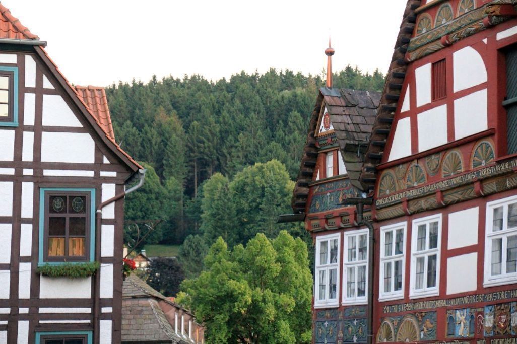 A traditional half-timbered building with a steeply pitched roof and a small tower.
