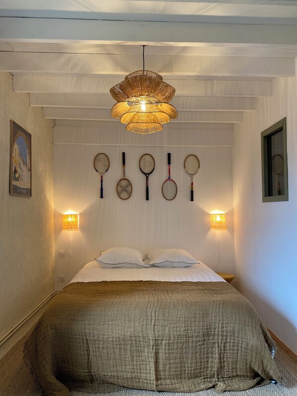 A bedroom with a bed, a hanging light fixture, wall-mounted lights, and a poster on the wall. - A Stunning House in the Heart of the Perche Region (by L'Oeil Nu) (Belforêt-en-Perche)