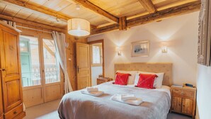 A cozy bedroom with a large bed, wooden headboard, and two bedside tables.