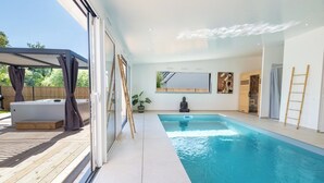 An indoor swimming pool with a wooden deck, a meditation area, and a large mirror on the wall. - LUXURY - Villa, swimming pool, jacuzzi, billiards by Groom* - by Groom (Erdeven)