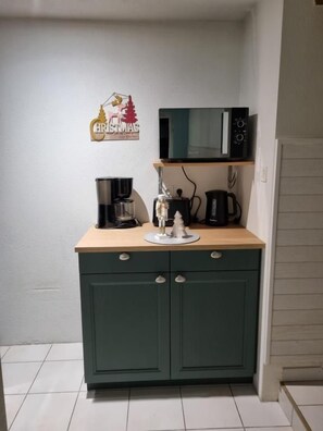 A kitchenette with a microwave, coffee maker, and a small cabinet. - At Mont de la Quintine (Saint-Quentin-sur-le-Homme)