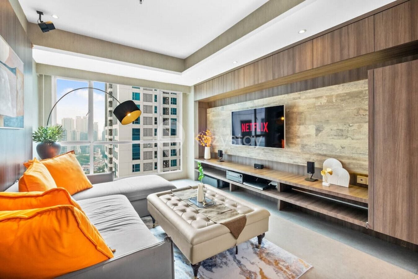 A modern living room with a large TV, a sofa, and a coffee table.