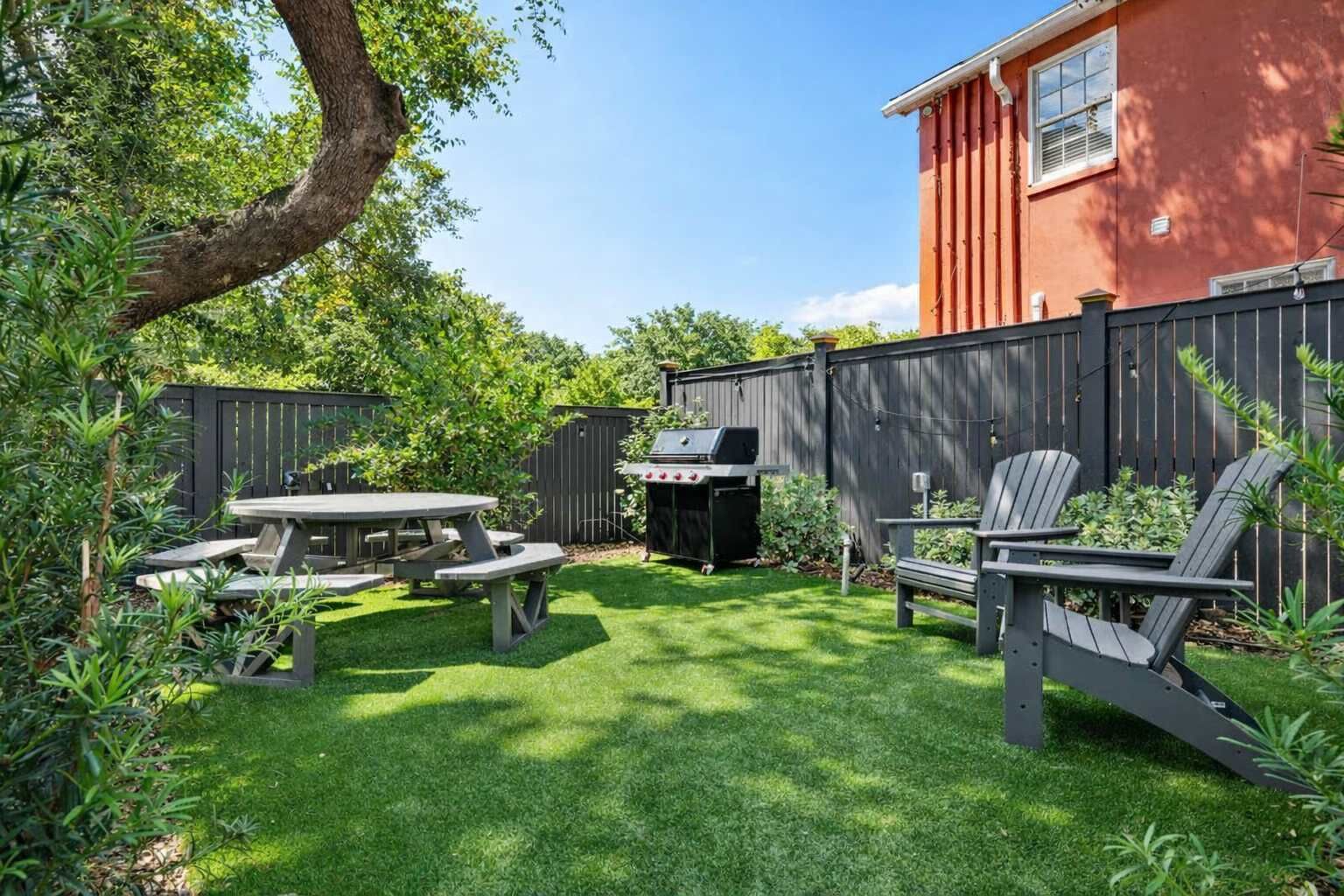 Outdoor common area space with seating and a grill.