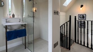 A modern bathroom with a glass shower enclosure, a white sink, and a blue towel. - Idyllic secluded hideaway with countryside views (Hailey)
