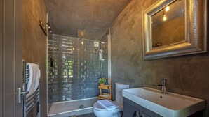 A compact bathroom with a shower, toilet, and sink. - Lavender Lodge  (Bath)
