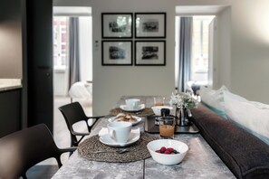 A breakfast setup with a table, chairs, a bowl of berries, a coffee cup, and a juice glass. - Shadows of Love (Como)