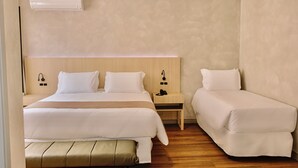 A hotel room with a large bed, a smaller bed, a bench, a bedside table with a phone, and an air conditioning unit on the wall. - POUSADA BIG BEAR 2 (Campos do Jordao)