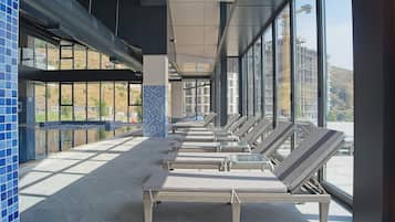 Indoor pool, seasonal outdoor pool, pool umbrellas, pool loungers