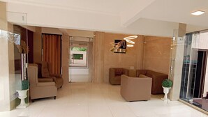 A modern living room with a sofa set, a chair, and a small table with a plant. - Ashwa Glory Retreat (Igatpuri)