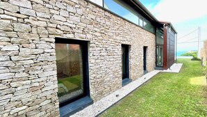 A modern building with a stone facade and large windows.