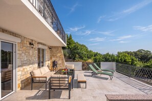 A modern outdoor patio with a sofa, chairs, and a dining table. - Hidden Pool House With Sea View (Novi Vinodolski)