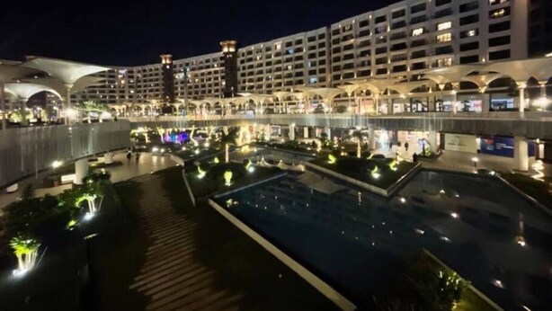 A modern hotel with multiple floors, a central courtyard with a pool, and a covered walkway. - MISK properties 2 bedroom duplex 2 (Cairo Governorate)
