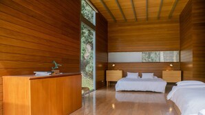 A modern bedroom with wooden walls, a wooden desk, two beds, and a large window. - w Elegant 5BR Home w Pool in Cieneguilla (Pachacámac)