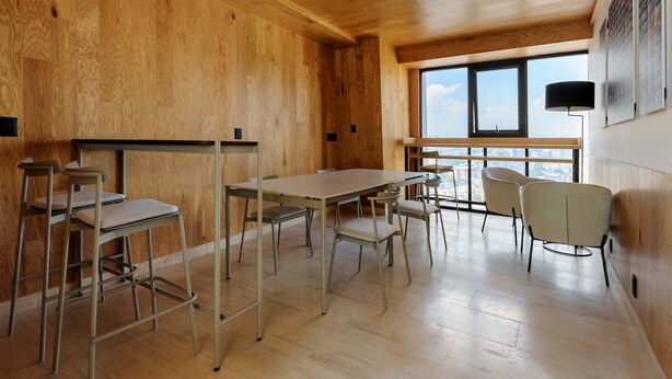 A spacious room with wooden walls and floors, a large window, and a table with chairs. - w Lovely 1BR Apartments w/ Amazing Deco in Cdmx (Mexico City)