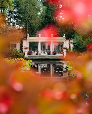 A gazebo with a water feature in front, surrounded by greenery. - Tranquil 1BR Villa in Revislate (Veruno)