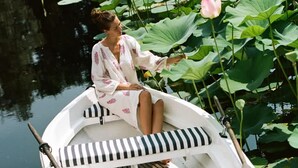A person in a boat with striped cushions, surrounded by lotus plants and water. - Tranquil 1BR Villa in Revislate (Veruno)