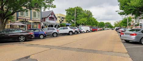 A street lined with parked cars and historic buildings.
