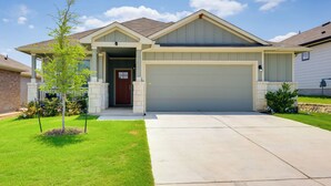 A single-story house with a garage, a covered porch, and a well-maintained lawn. - 3 Mi to Dtwn Kyle: Wfh-friendly Home w/ Patio (Kyle)