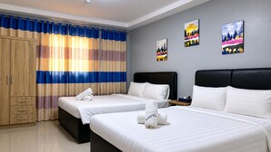 A hotel room with two beds, a wardrobe, and artwork on the wall. - Valentine Hotel Angeles City managed by Cocotel (Angeles City)