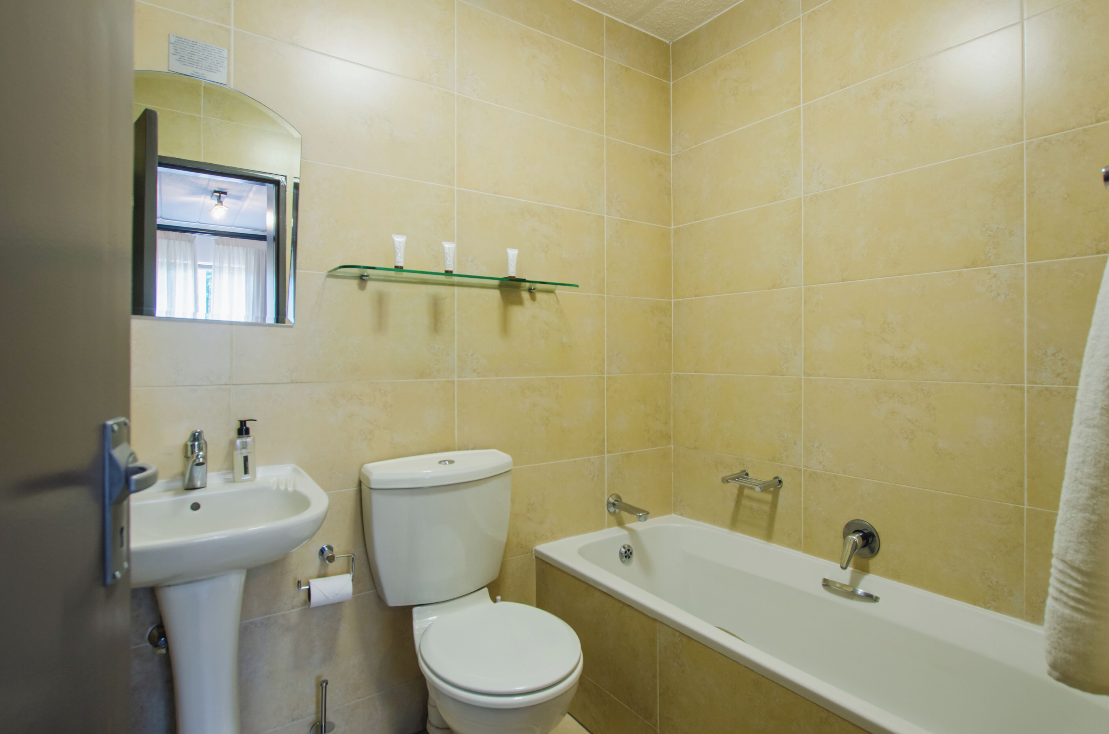 A bathroom with a sink, toilet, and bathtub.