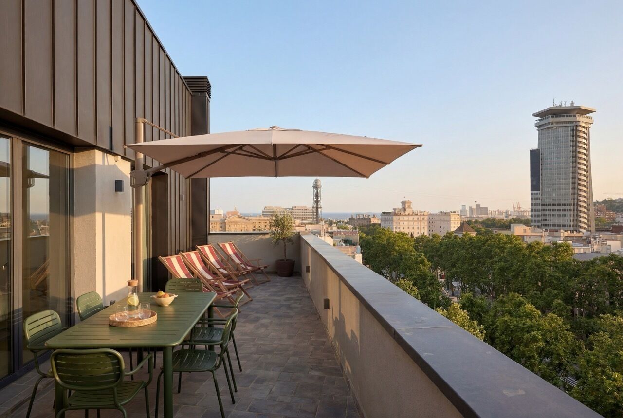 A rooftop terrace with a table, chairs, and an umbrella, overlooking a cityscape.