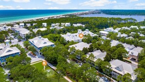 A coastal residential area with houses, a beach, and a marina.