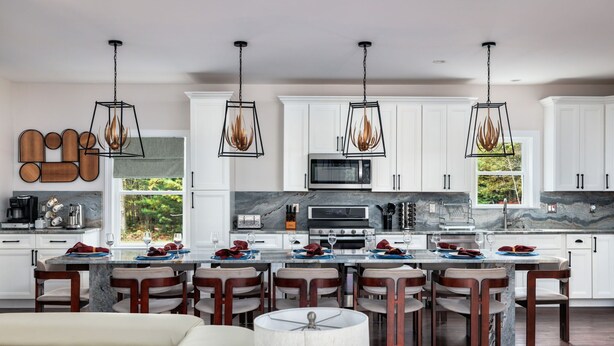 A modern kitchen with white cabinets, a central island with seating, and pendant lighting. - Luxury Poconos Estate*Golf Sim*Pickleball*Sauna (Long Pond)