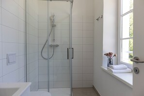 Shower, hair dryer, towels, toilet paper