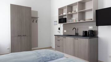 Mini-fridge, microwave, stovetop, cookware/dishes/utensils