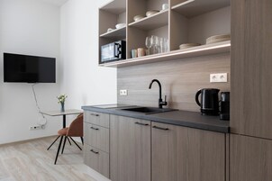 Mini-fridge, microwave, stovetop, cookware/dishes/utensils