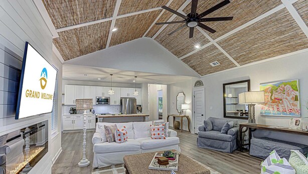 A spacious living area with a kitchen, a dining area, and a seating area with a ceiling fan. - 6BD Retreat for 14 Fire Pit | Patio | Lake Access (Cottonwood Shores)