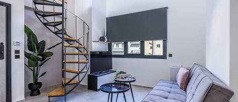 Una sala de estar moderna con una escalera espiral, un sofá, una mesa de centro y una planta en maceta.